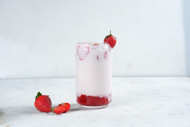 A glass of korean strawberry milk and berriesbright moodwhite background