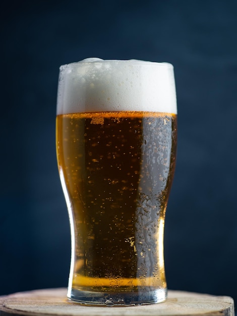 A glass of lager light beer on a dark background