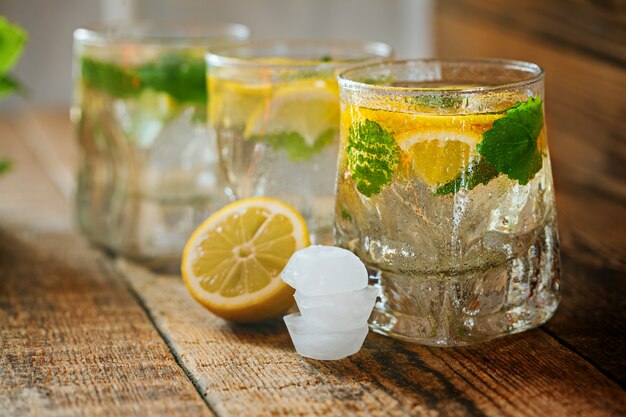 Glass of lemonade with fresh lemon and mint 