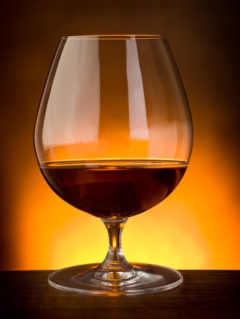 Glass of liquor on wood table