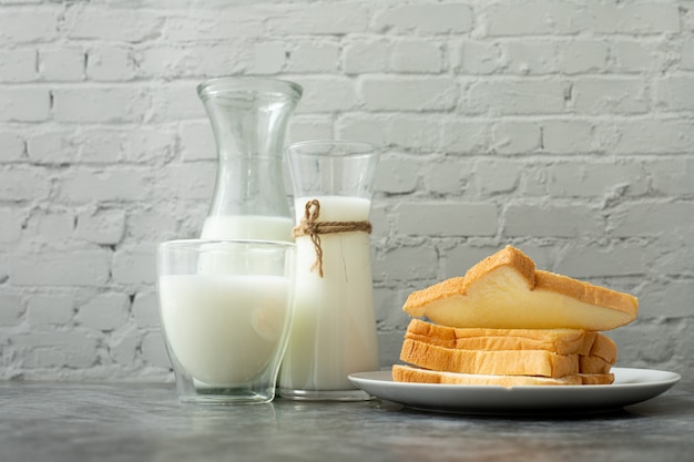 Glass of Milk and slice bread on kitchen table.