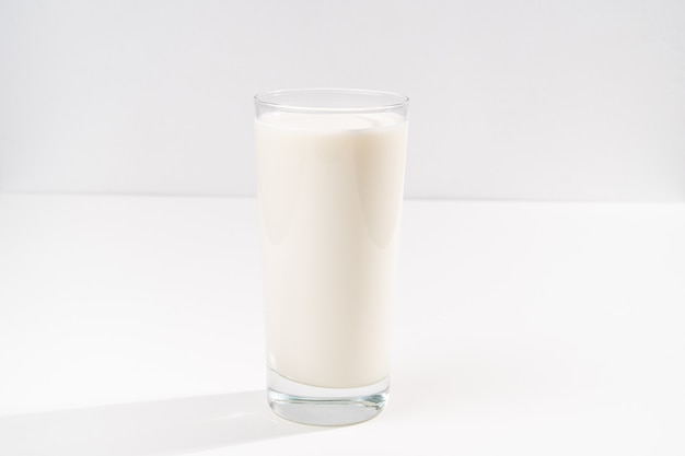 A glass of milk on a white background. selling farm products. Place for the inscription.