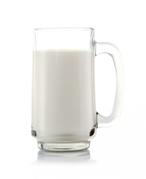 Glass of milk on white wall