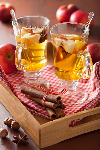 Glass of mulled cider with orange and spices