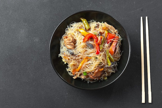 Glass noodle with vegetable in a black bowl on a grey background asian food asian cuisine asian or s