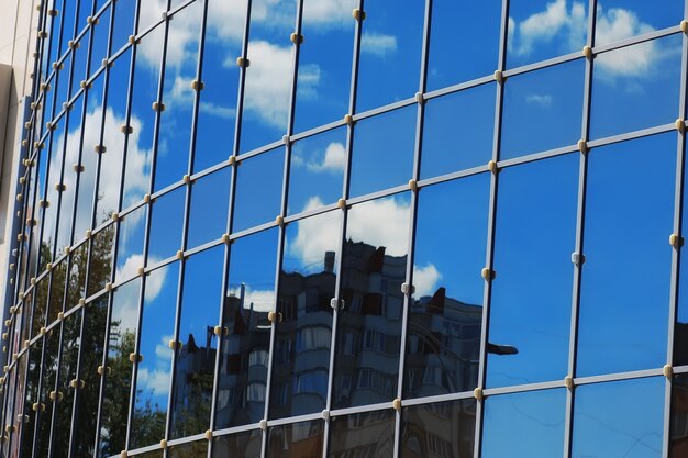 Glass office building reflection sky cloud