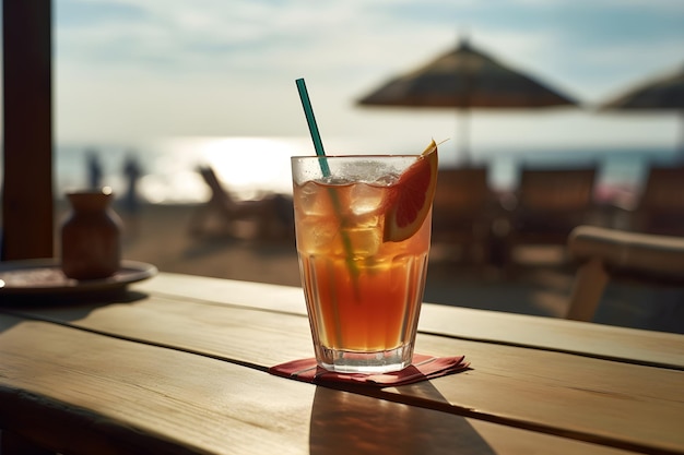 A glass of orange drink with a green straw on the table.