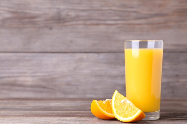 Glass of orange juice on wooden table