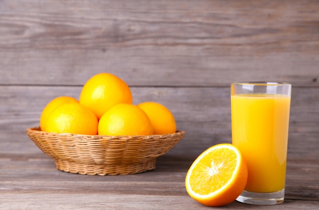 Glass of orange juice on wooden table