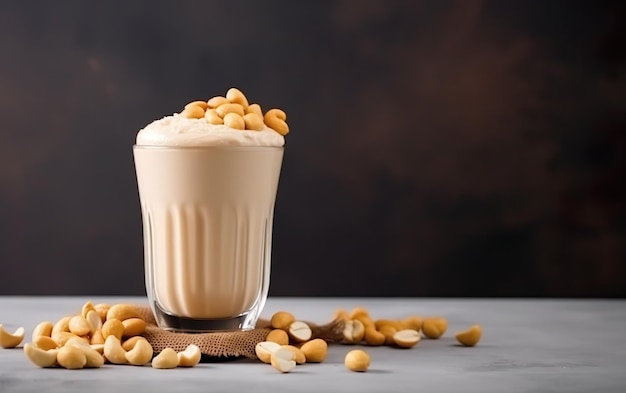 A glass of peanut milk with peanuts on the side