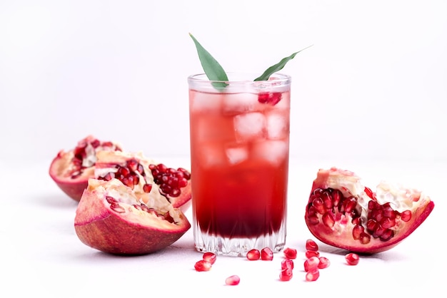 Glass of Pomegranate Juice with Ice and Fresh Pomegranate Fruits on White Backgroud Detox Drink