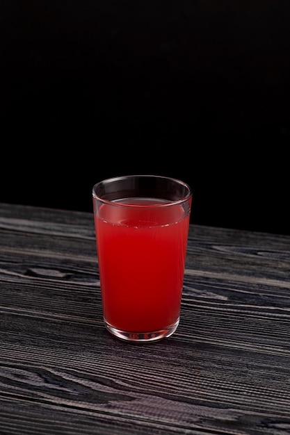 Glass of Red fruit Tepache drink Fermented beverage made from peel and rind of pineapples