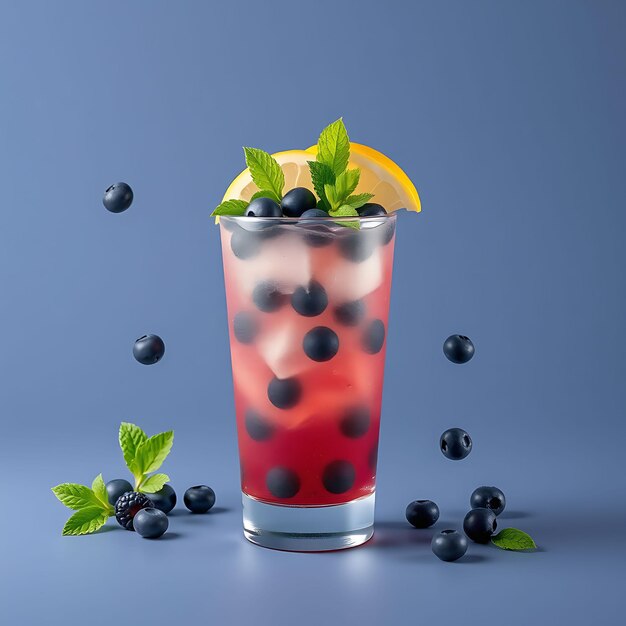 Photo a glass of red liquid with blackberries and a lemon wedge