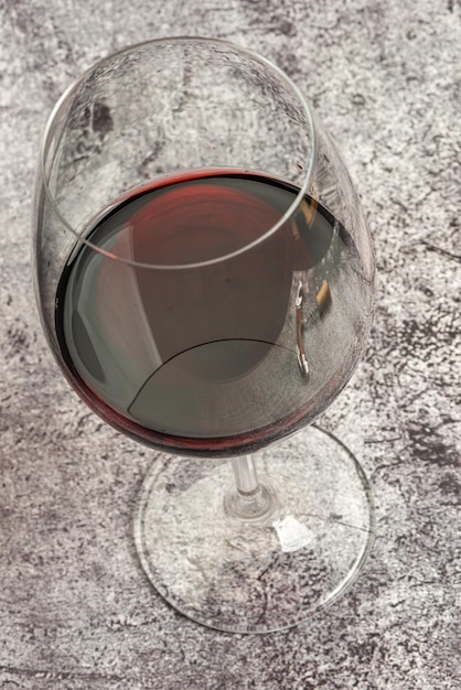 Glass of red wine on endless marbled background