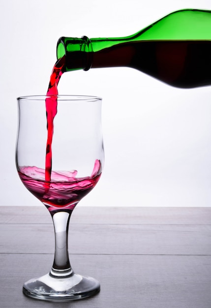 glass of red wine .glass of wine on a light wooden background