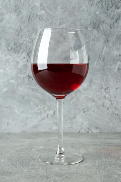 Glass of red wine on gray textured table