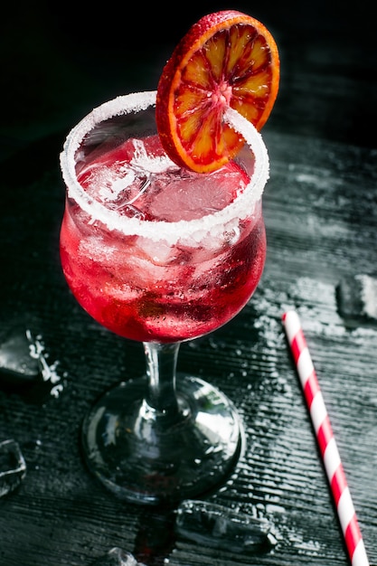 Glass of refreshing citrus cocktail with ice