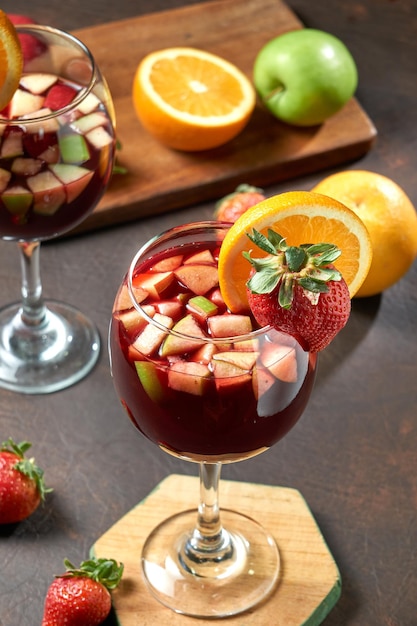 glass of sangria with orange and strawberry decoration