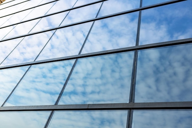 Glass skyscraper against blue sky view from bottom