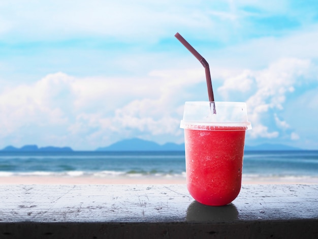 Glass of smoothie watermelon juice on wooden table 