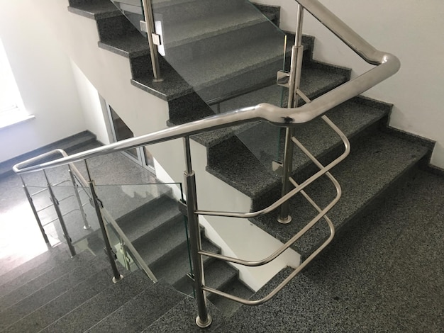 A glass staircase with a black ceiling and a white ceiling.