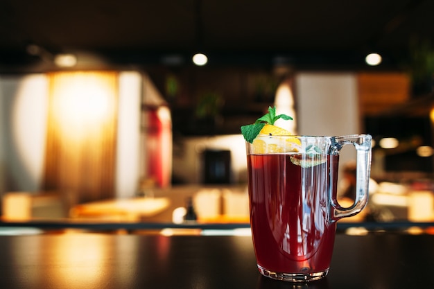 Glass of tasty red punch on restaurant table.