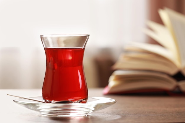 Glass of traditional Turkish tea on wooden table closeup Space for text