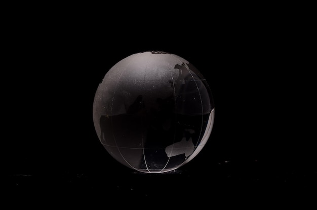 Photo glass transparent globe earth on a black background