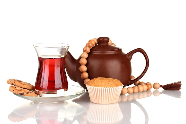 Glass of Turkish tea and kettle isolated on white