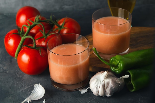 Glass of typical spanish tomato soup andalusian gazpacho with fresh vegetables