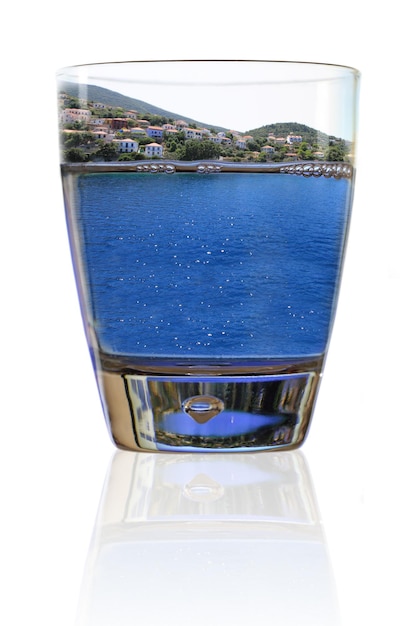 Glass of vacation Greek island in a glass of water