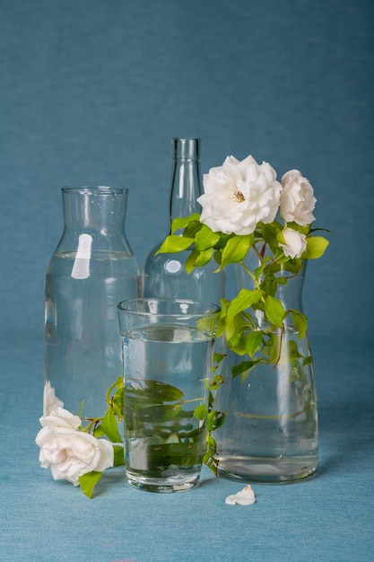 glass vase composition combined with white roses