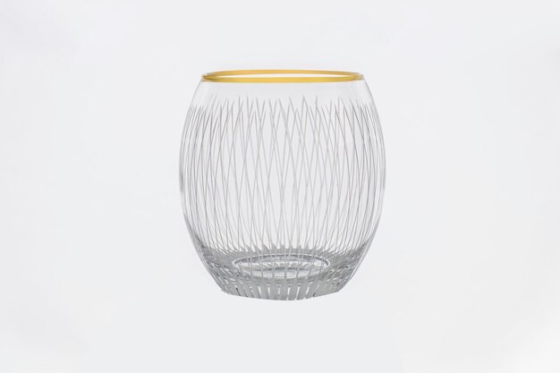 Photo a glass vase with a gold rim is on a white background