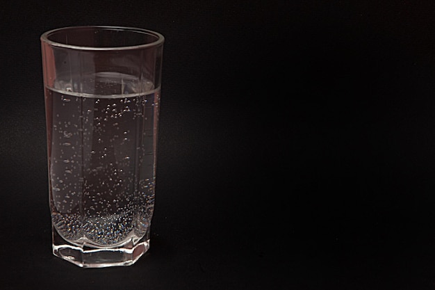 A glass of water black background