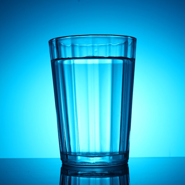 A glass of water on a blue background