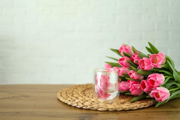 Glass of water and bunch of flowers good morning concept