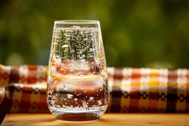 A glass of water in the garden background.