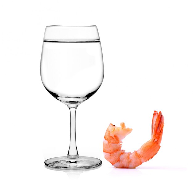 Glass of water and shrimps isolated on white background