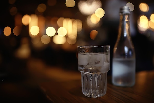 glass of water with ice in the restaurant / cold clear clear water in a glass with ice pieces