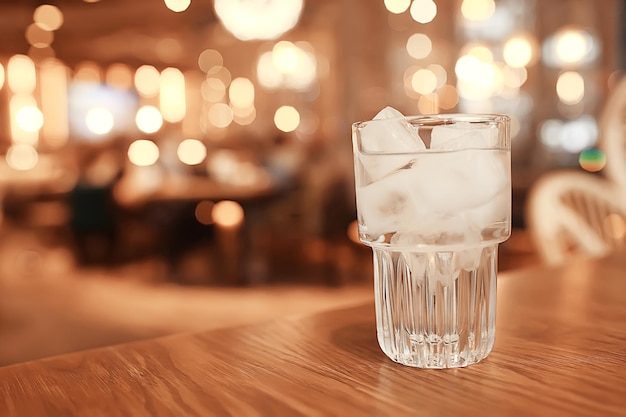 glass of water with ice in the restaurant / cold clear clear water in a glass with ice pieces