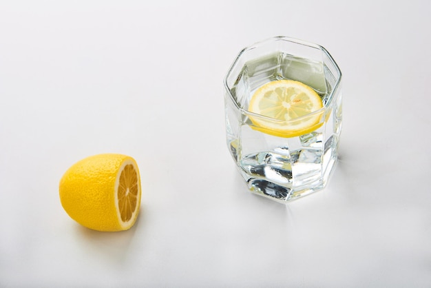 glass of water with lemon for healthy morning awakening of the body on white background