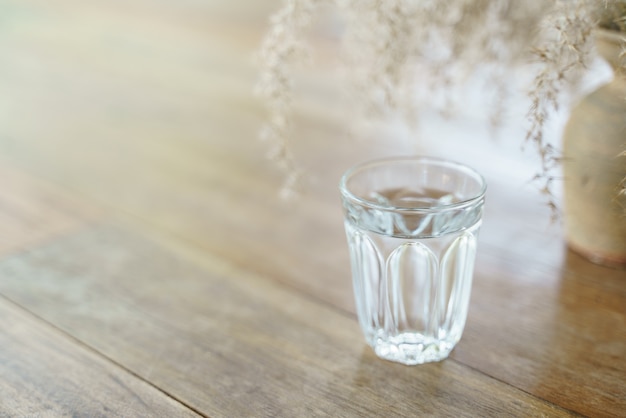 Glass of water on wooden table