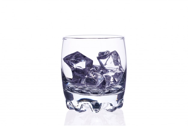 A glass of whiskey with ice cubes on a white background isolate.