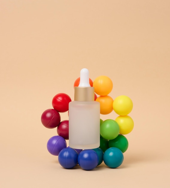 A glass white bottle with a dropper on a beige background a container for cosmetic products