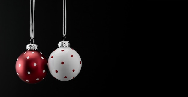 Glass white and red Christmas ornaments on a black background