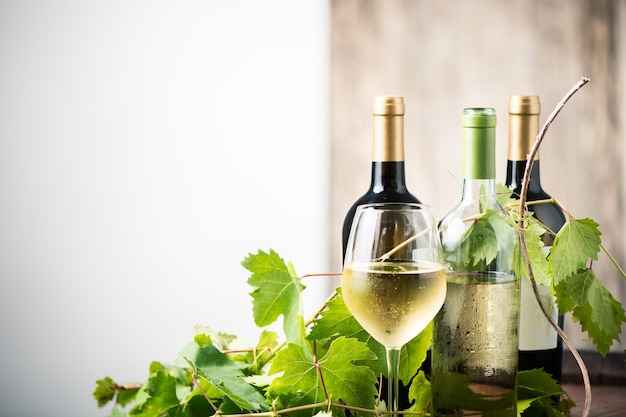 Glass of white wine on a barrel on white background