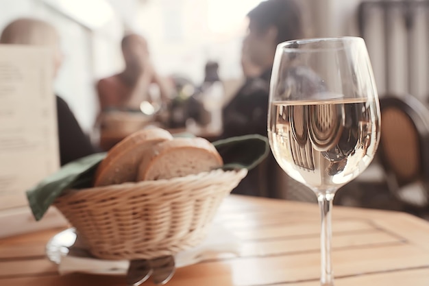 glass of white wine in the restaurant / white wine in the interior of the restaurant a table with glasses of wine, a romantic summer