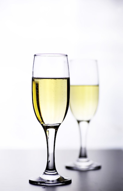 glass of white wine on a table on a white background isolate