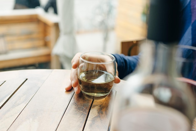 Glass of white wine on vintage wooden table in restaurant