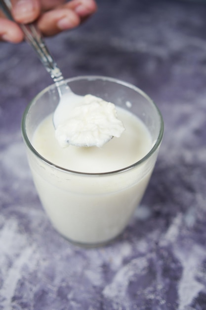 Glass of whole cream milk on table  cream of milk